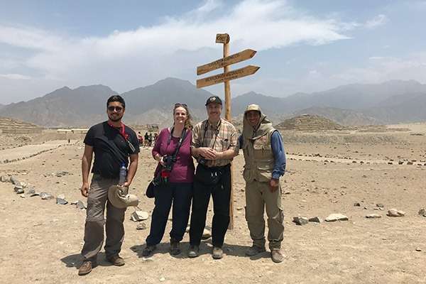 Local guide with visitors at Caral