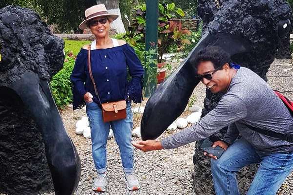 Tourists having fun in Barranco with vulture statues