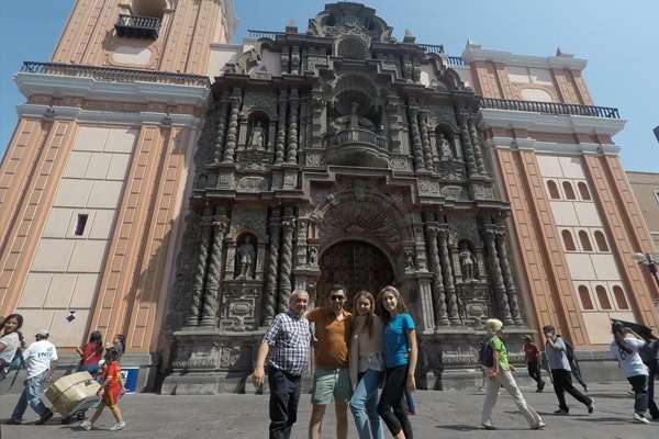 Family posing in front of Barroque style church