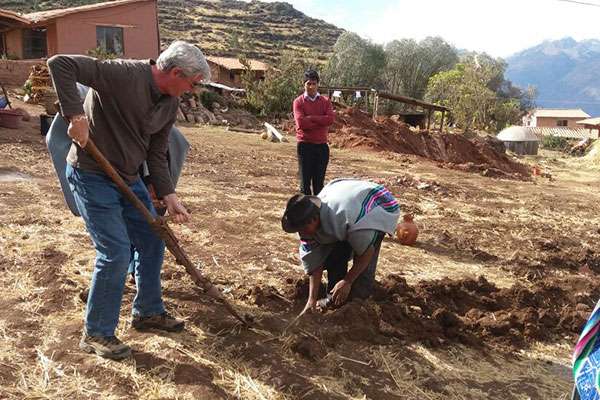 Man plowing with local andean villagers