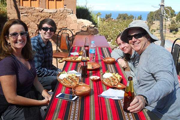 Family Eating Trout in Taquile Island