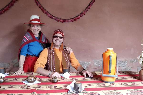 Travelers in andean village dressed up at locals