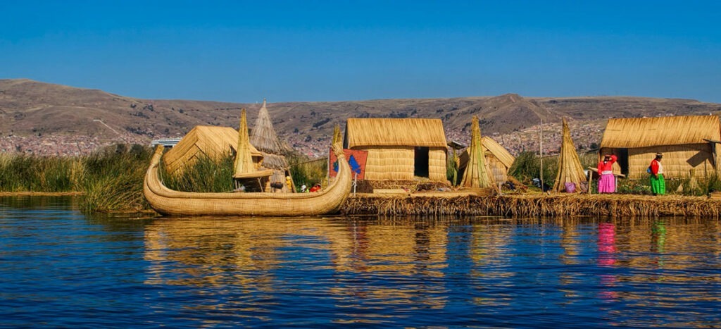 reed boat and houses in titicaca lake